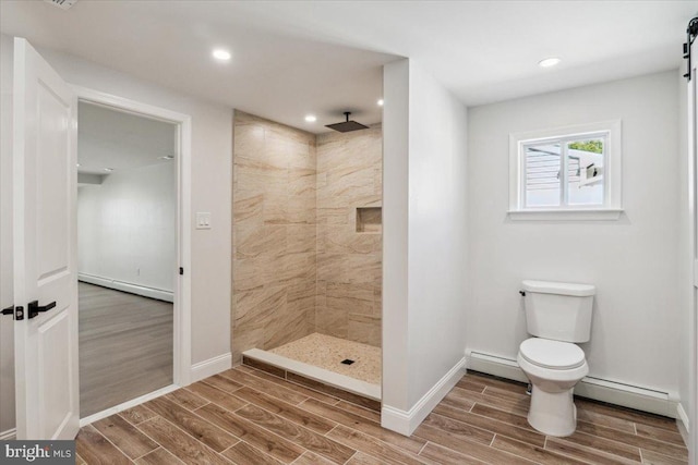 119 Oaktree Dr, Levittown, PA 19055 - bathroom featuring a baseboard heating unit, wood finish floors, a baseboard radiator, a tile shower, and recessed lighting