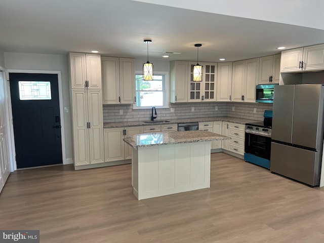 119 Oaktree Dr, Levittown, PA 19055 - kitchen with appliances with stainless steel finishes, a sink, light stone countertops, decorative backsplash, and recessed lighting