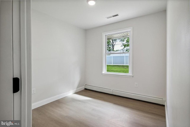 119 Oaktree Dr, Levittown, PA 19055 - empty room with a baseboard radiator, wood finished floors, and baseboards