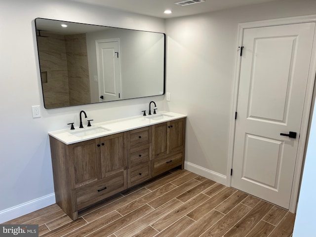 119 Oaktree Dr, Levittown, PA 19055 - bathroom with wood tiled floors, baseboards, double vanity, and recessed lighting
