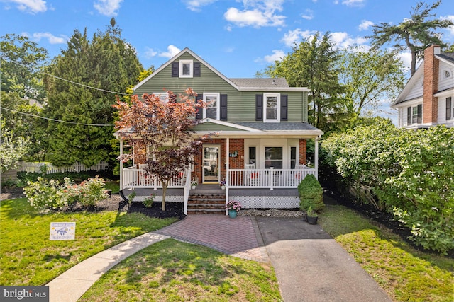 717 E Greenman Rd, Haddonfield, NJ 08033 - view of front of property with a porch, a front lawn, a shingled roof, and brick siding