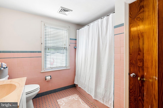 717 E Greenman Rd, Haddonfield, NJ 08033 - full bath featuring tile walls, healthy amount of natural light, vanity, a wainscoted wall, and toilet