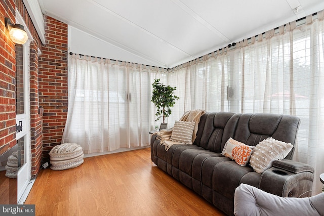 717 E Greenman Rd, Haddonfield, NJ 08033 - living room featuring vaulted ceiling, wood finished floors, and brick wall