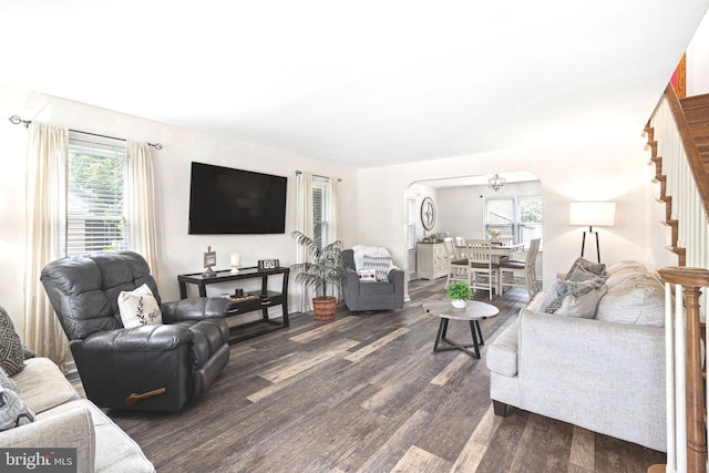 717 E Greenman Rd, Haddonfield, NJ 08033 - living room featuring dark wood-style flooring, plenty of natural light, arched walkways, and stairs