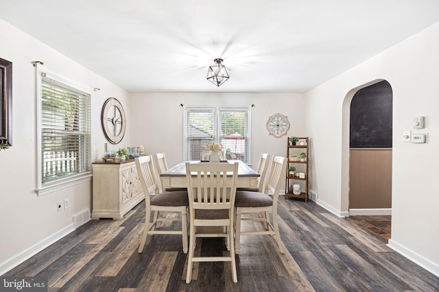 717 E Greenman Rd, Haddonfield, NJ 08033 - dining space featuring dark wood-style flooring, arched walkways, and baseboards