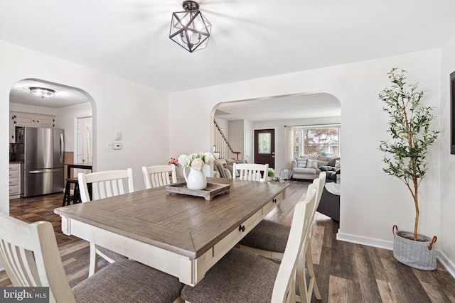 717 E Greenman Rd, Haddonfield, NJ 08033 - dining area featuring arched walkways, dark wood-type flooring, and stairs