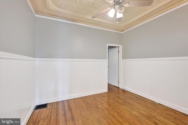 1407 Clarkson St, Baltimore, MD 21230 - spare room featuring hardwood / wood-style flooring, ceiling fan, a wainscoted wall, baseboards, and crown molding