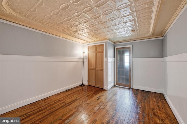 1407 Clarkson St, Baltimore, MD 21230 - unfurnished bedroom with wood-type flooring, an ornate ceiling, crown molding, wainscoting, and baseboards