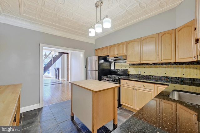 1407 Clarkson St, Baltimore, MD 21230 - kitchen featuring appliances with stainless steel finishes, light brown cabinets, under cabinet range hood, an ornate ceiling, and tasteful backsplash