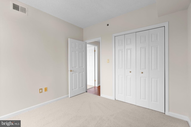 930 Astern Way Unit 502, Annapolis, MD 21401 - unfurnished bedroom with carpet flooring, baseboards, a closet, and a textured ceiling