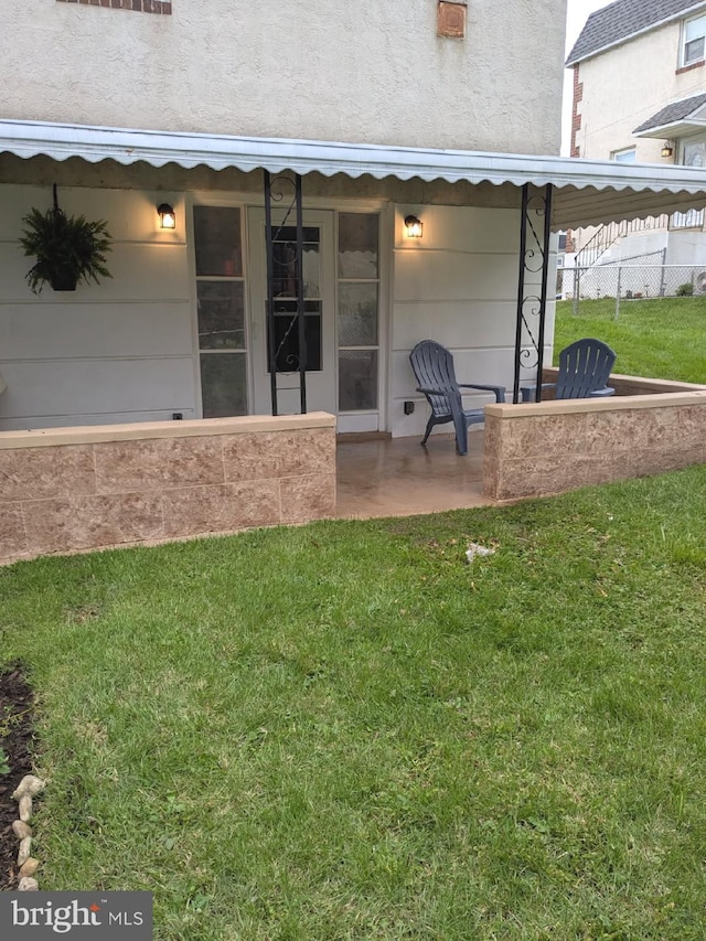 rear view of house featuring stucco siding