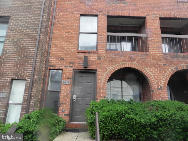 property entrance with brick siding