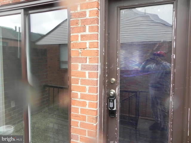 view of exterior entry with brick siding