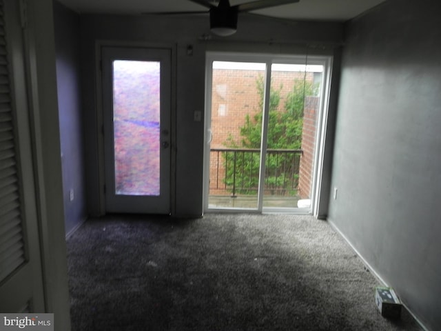 unfurnished room with carpet flooring, ceiling fan, healthy amount of natural light, and baseboards
