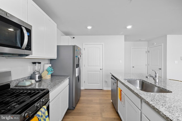 1638 Terrapin Cir, Cambridge, MD 21613 - kitchen featuring appliances with stainless steel finishes, a sink, recessed lighting, white cabinetry, and light wood-style floors