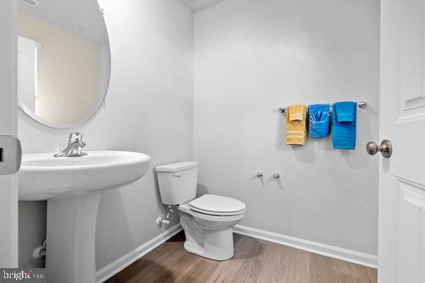 1638 Terrapin Cir, Cambridge, MD 21613 - bathroom with wood finished floors, toilet, baseboards, and a sink