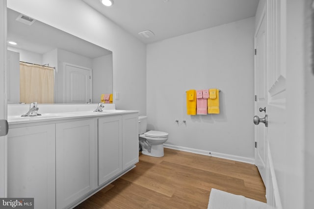 1638 Terrapin Cir, Cambridge, MD 21613 - full bathroom featuring toilet, baseboards, wood finished floors, recessed lighting, and double vanity