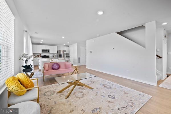 1638 Terrapin Cir, Cambridge, MD 21613 - living area with light wood-type flooring, recessed lighting, baseboards, and stairway