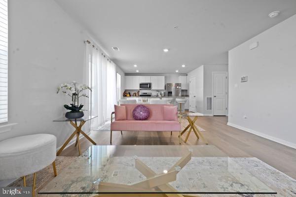 1638 Terrapin Cir, Cambridge, MD 21613 - living room with light wood finished floors, baseboards, and recessed lighting