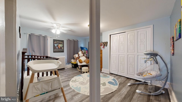 504 SE Front St, Milford, DE 19963 - bedroom with radiator, wood finished floors, baseboards, and a ceiling fan