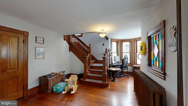 504 SE Front St, Milford, DE 19963 - entrance foyer featuring radiator heating unit, wood finished floors, stairway, and baseboards