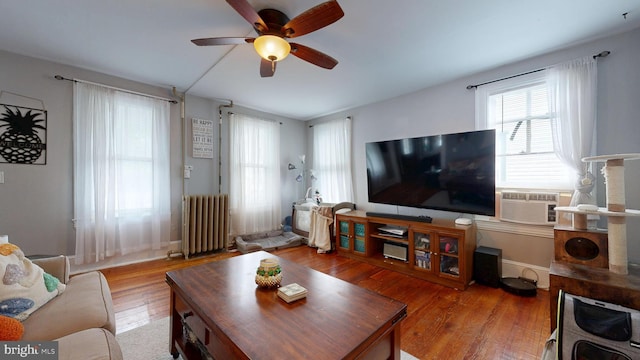 504 SE Front St, Milford, DE 19963 - living room featuring radiator heating unit, ceiling fan, wood finished floors, cooling unit, and baseboards