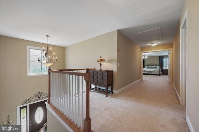 99 Topaz Ln, Camden Wyoming, DE 19934 - hall featuring attic access, light carpet, baseboards, a chandelier, and an upstairs landing