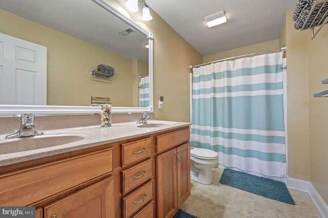 99 Topaz Ln, Camden Wyoming, DE 19934 - bathroom featuring toilet, double vanity, curtained shower, and tile patterned flooring