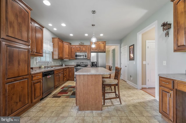 99 Topaz Ln, Camden Wyoming, DE 19934 - kitchen featuring appliances with stainless steel finishes, a breakfast bar area, recessed lighting, light countertops, and baseboards