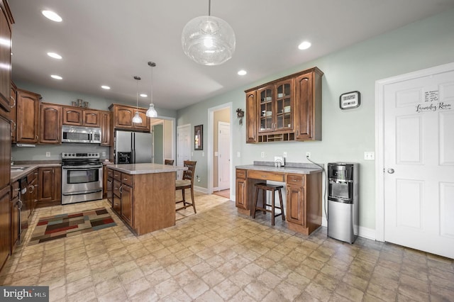 99 Topaz Ln, Camden Wyoming, DE 19934 - kitchen featuring stainless steel appliances, a kitchen breakfast bar, baseboards, recessed lighting, and glass insert cabinets