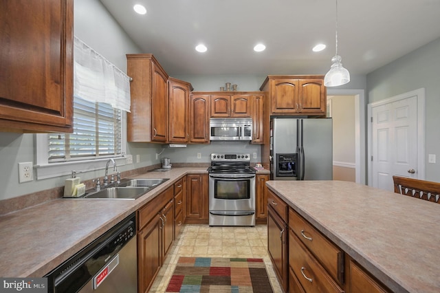 99 Topaz Ln, Camden Wyoming, DE 19934 - kitchen with stainless steel appliances, a sink, pendant lighting, recessed lighting, and brown cabinetry