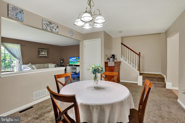 carpeted dining area with a chandelier, stairs, and baseboards