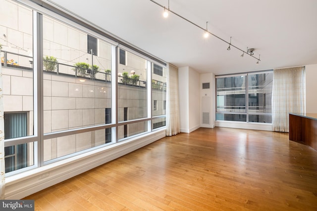 1414 S Penn Sq Unit 9A, Philadelphia, PA 19102 - spare room with wood finished floors, rail lighting, and baseboards