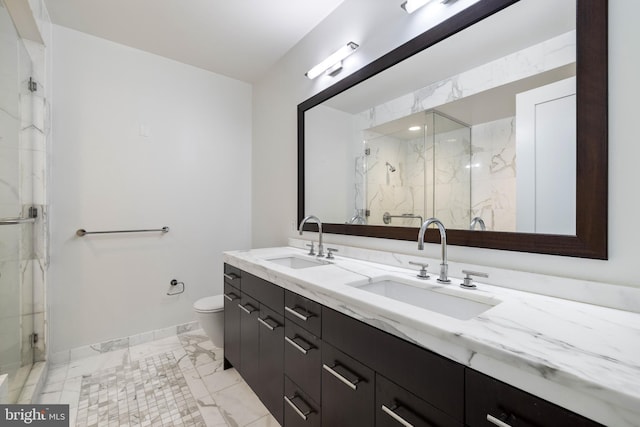 1414 S Penn Sq Unit 9A, Philadelphia, PA 19102 - full bath featuring marble look tiles, a marble finish shower, double vanity, toilet, and baseboards