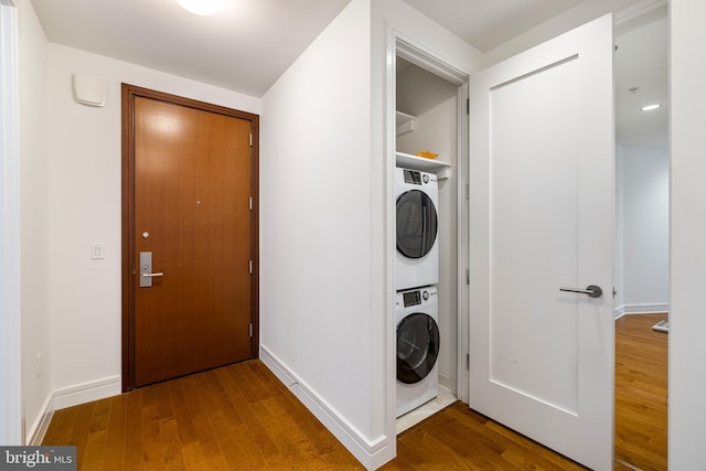 1414 S Penn Sq Unit 9A, Philadelphia, PA 19102 - laundry area featuring stacked washer / dryer, wood finished floors, and baseboards