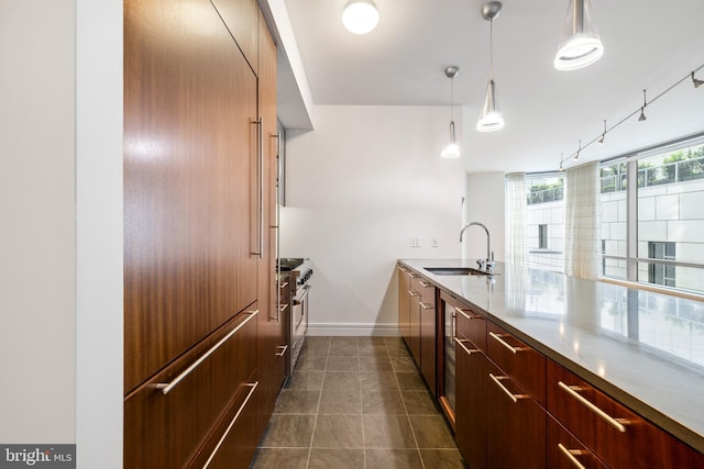 1414 S Penn Sq Unit 9A, Philadelphia, PA 19102 - kitchen featuring a sink, dark tile patterned flooring, baseboards, premium appliances, and modern cabinets