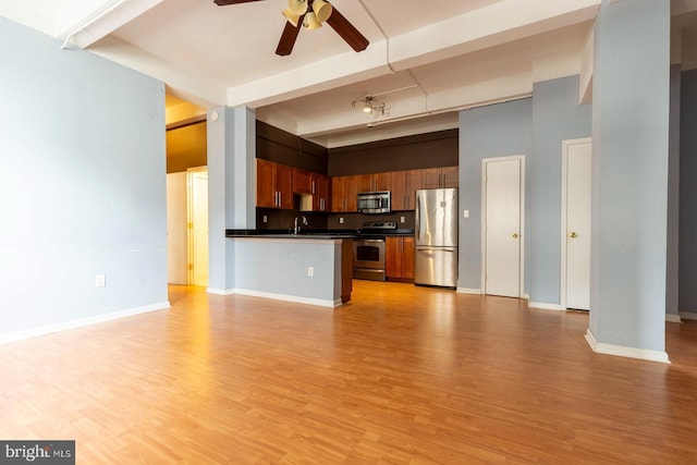 1324 Locust St Unit 1602, Philadelphia, PA 19107 - kitchen featuring appliances with stainless steel finishes, open floor plan, dark countertops, ceiling fan, and a sink