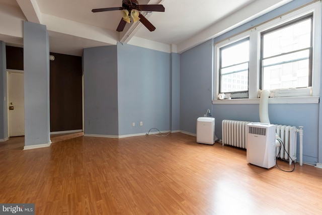 1324 Locust St Unit 1602, Philadelphia, PA 19107 - empty room with radiator heating unit, a ceiling fan, wood finished floors, baseboards, and beamed ceiling