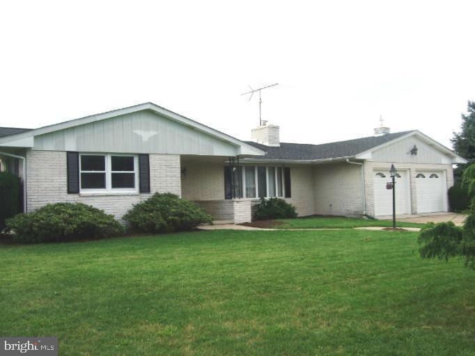 1803 Motter Rd, Westminster, MD 21158 - ranch-style home with brick siding, an attached garage, a front yard, and a chimney