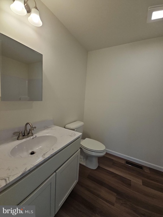 213 Newport Rd, Millville, NJ 08332 - bathroom with wood finished floors, toilet, vanity, and baseboards