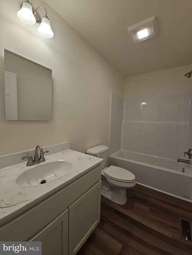 213 Newport Rd, Millville, NJ 08332 - full bath with wood finished floors, toilet, vanity, and shower / washtub combination