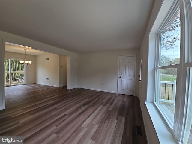 213 Newport Rd, Millville, NJ 08332 - unfurnished living room with a chandelier, dark wood-type flooring, and baseboards