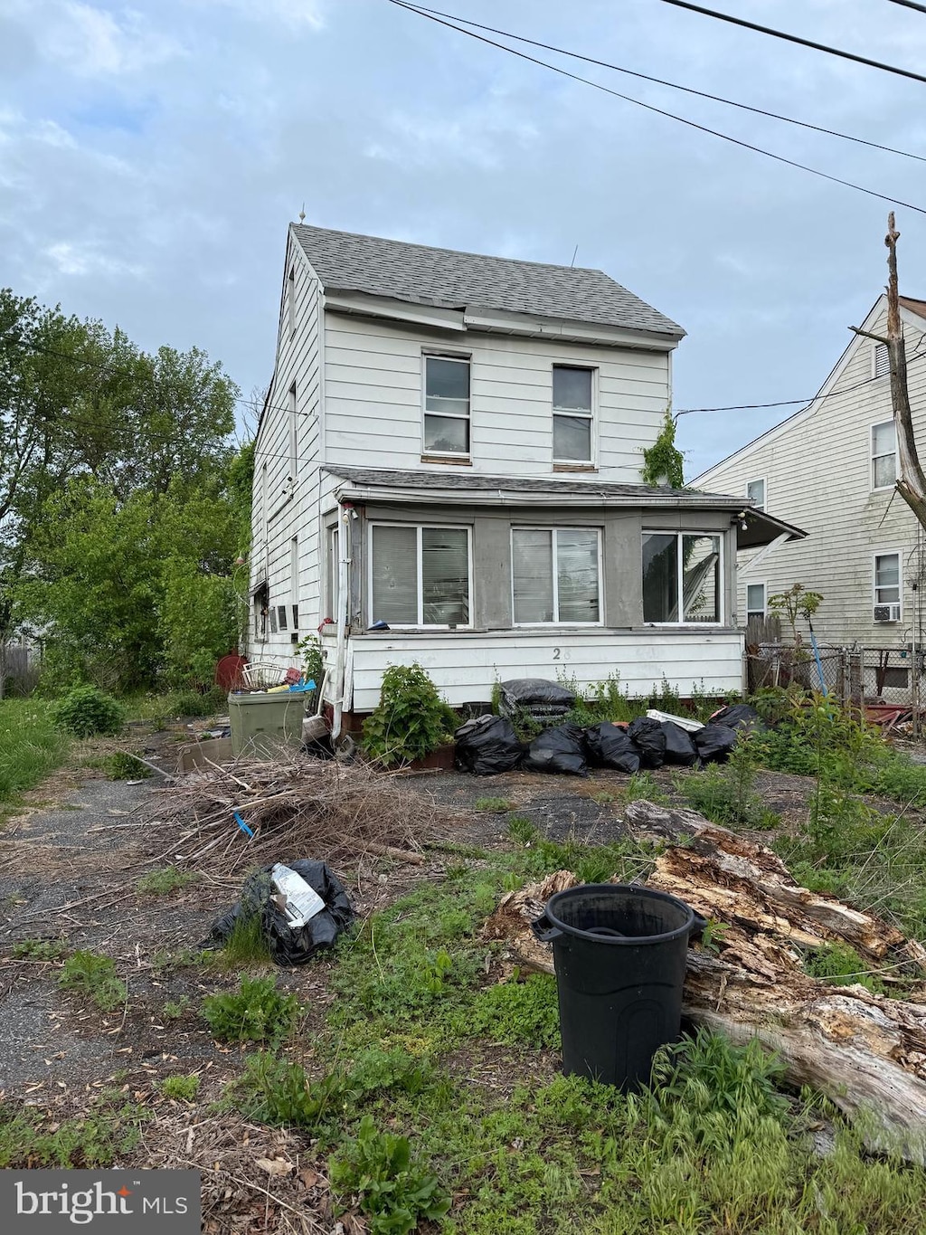 view of front of house with roof with shingles and fence