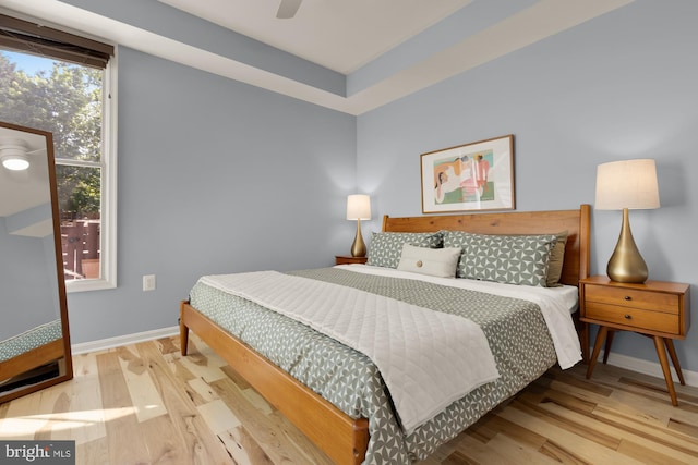 bedroom featuring wood finished floors, baseboards, and ceiling fan