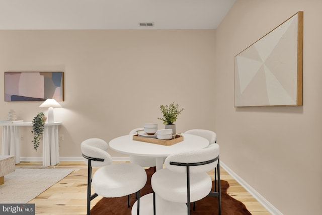 dining room with wood finished floors and baseboards
