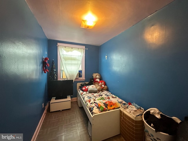 bedroom with baseboards and vaulted ceiling
