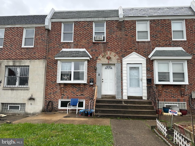 townhome / multi-family property with brick siding and entry steps