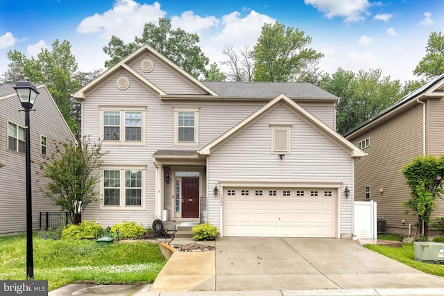 traditional-style house with driveway, an attached garage, and fence