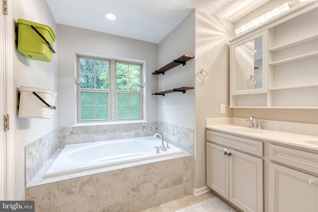 full bathroom with a garden tub, double vanity, and tile patterned floors