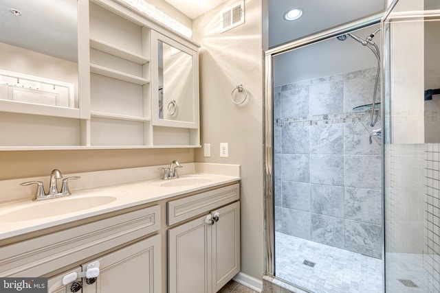 bathroom featuring a shower stall and double vanity